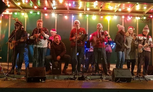 Alresford Ukulele Jam play to the crowd at The Arrival of Father Christmas in Broad Street